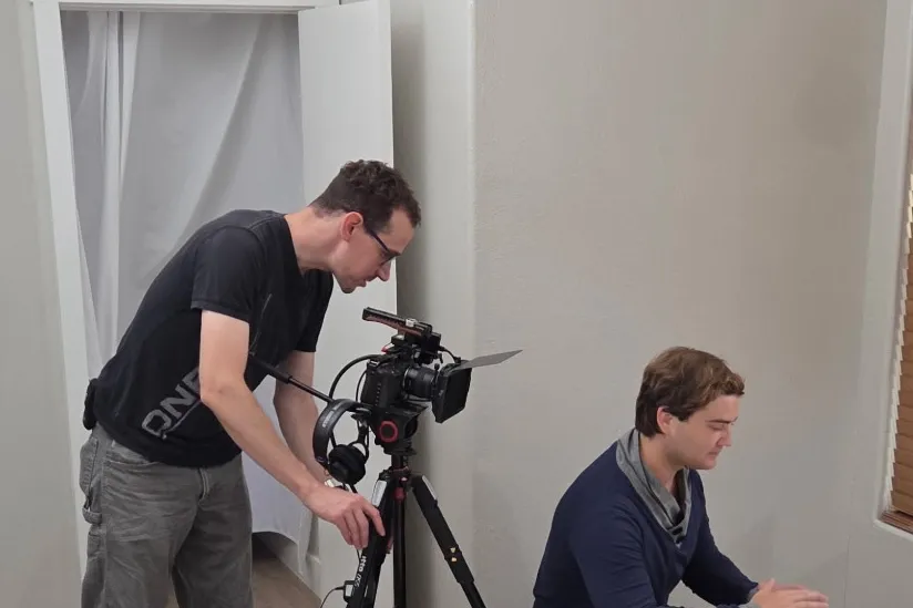 Ryan operating a camera beside Luke, the actor playing Carter, on the set of Skyglass.